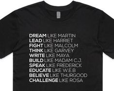 a black t - shirt with the words dream written in white on it, against a white background