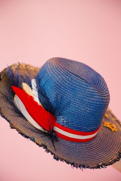 Sail into the summer with our BON VOYAGE SUN HAT! This stylish blue and gold hat features a bold red and white striped ribbon band and a playful gold sailboat pin. Finished with a patriotic red, white, and blue feather combo, it's perfect for any beach day or boat trip. This hat is ONE OF A KIND, created by our owner Stephanie. To receive item quicker, expedited shipping is available at checkout. Red Beach Hat For 4th Of July, Patriotic Blue Beach Hat, Blue Curved Brim Hat For 4th Of July, Red Hat For Beach And 4th Of July, Patriotic Beach Hats For Spring, Patriotic Beach Hat For Spring, Patriotic Hats For Beach In Spring, 4th Of July Beach Hat With Wide Brim, 4th Of July Wide Brim Beach Hat