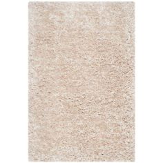 an area rug with white shag on the top and light beige carpet below it