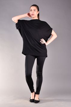 "Black Top, Womens Blouse, Plus Size Clothing, Casual Top. Modern hip length top in black. This short sleeve top is oversized and has very loose fit cut which hides the imperfections and makes you feel comfortable and beautiful at the same time. The plus size top features so trendy cut out back with draped style. Match it with black leggings and add a colour popping handbag to finish the look. ^ Sizes: The item can be made in sizes from XXS to 7XL. Please, use the size chart below or if you are Versatile Batwing Sleeve Tops For Workwear, Versatile Batwing Sleeve Workwear Tops, Oversized Short Sleeve Top, Black Stretch Tops With Batwing Sleeves, Black Stretch Batwing Sleeve Tops, Oversized Versatile Top, Versatile Stretch Blouse With Short Sleeves, Versatile Stretch Short Sleeve Blouse, Versatile Oversized Black Tops