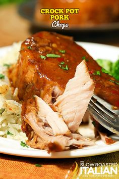 a close up of a plate of food with meat and rice on it, with the title crock pot pork chops