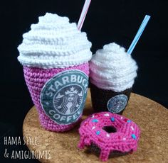 two crocheted cup cozyies and a doughnut are sitting on a table