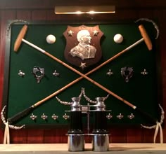 a wall mounted display with baseball bats and other items on it's back drop