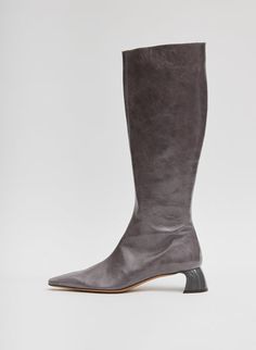 A knee-high boot designed to step you through Fall—and winter too—the Boris Boot features an ultra-shiny patent leather in hues across the Tibi Color Wheel and a total, semi-shiny heel for added depth, this style will single-handedly provide that good ick your closet craves. A zipper finish—becau...