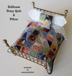 the dollhouse crazy quilt and pillow is on display