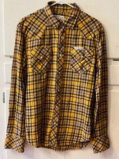 Vintage True Religion brand jeans Flannel, long sleeve button up, styled in California, size large. Yellow blue and black plaid. Pearl buttons down the front, pockets, and cuffs. Very Soft. Horseshoe stitching on the pockets. 21.5" flat P2P (up to 43" Chest). In excellent condition. Free Shipping Yellow Fitted Shirt For Fall, Yellow Long Sleeve Flannel Shirt For Fall, Fitted Yellow Shirt For Fall, Fitted Long Sleeve Flannel Shirt, Casual Yellow Button-up Flannel Shirt, Yellow Shirt With Button Closure For Fall, Fitted Plaid Flannel Shirt With Long Sleeves, Fitted Plaid Flannel Shirt With Button Closure, Plaid Long Sleeve Western Flannel Shirt