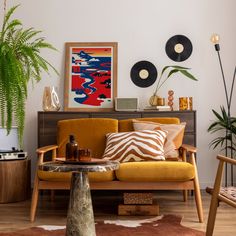 a living room filled with lots of furniture next to a potted plant on top of a table