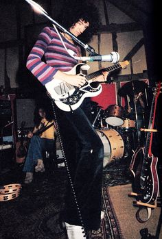 a man with an electric guitar on stage