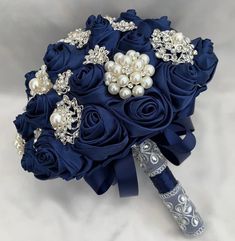 a bridal bouquet with blue roses and pearls