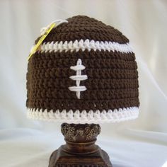 a crocheted football hat on top of a lamp