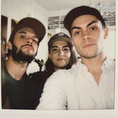 two men and a woman posing for a photo