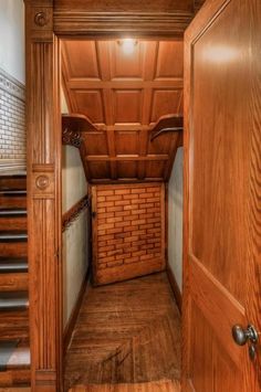 an empty wooden room with stairs leading up to the second floor