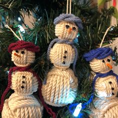 knitted snowman ornaments hanging from a christmas tree