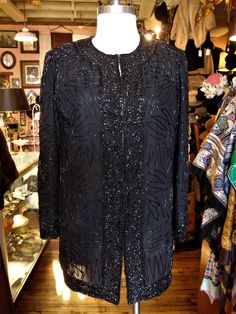 "This is a vintage beaded evening jacket by Brilliante from the 1980's or 90's. It closes down the front with sets of hooks and eyes, is lined and has removable shoulder pads. Great for the holidays! It's in great condition! Comes from a smoke free home. Measurements: Bust: 38\" Waist: 38\" Hip: 40\" Across Shoulder: 15\" Sleeve Length: 23\" Length from Shoulder: 31.5\" Please ask me any questions you may have before buying as this is a final sale. Please know your measurements and allow for mov Sequined Outerwear For Holiday Evenings, Vintage Formal Outerwear With Sequins, Vintage Sequined Formal Outerwear, Vintage Formal Sequined Outerwear, Embellished Holiday Outerwear For Evening Events, Holiday Evening Embellished Outerwear, Black Holiday Evening Outerwear, Fitted Beaded Evening Outerwear, Vintage Sequin Outerwear For Night Out