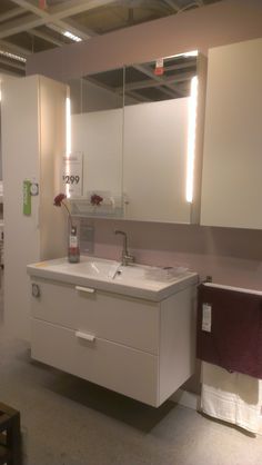 a bathroom with a sink, mirror and towel rack in it's display area