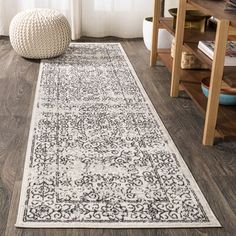 a white and black rug in a living room