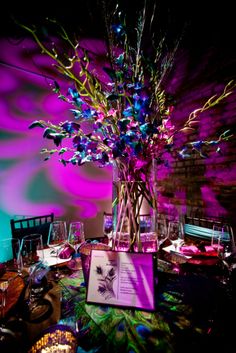 the table is set with purple and blue flowers