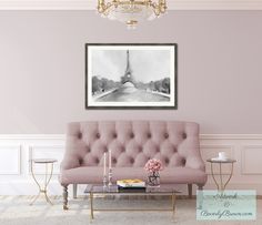 a living room with a couch, coffee table and chandelier