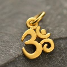 Ohm Charm. Ohm is a holy meditation symbol of Hinduism and Buddhism with a profusion of meanings. In modern usage Ohm means the Word, the parnava, the eternal and divine. Ohm is also said to be the term of assent used by the gods and the name given by the Hindus to the spiritual sun. Available in Large and Tiny sizes. Measurements: Large - Length: 20mm Width: 15mm Height: 1mmTiny - Length: 13mm Width: 7mm Height: 1mm-Measurement includes 5mm jump ring. Available in Sterling Silver, Natural Bronz Spiritual Sun, Ohm Jewelry, Meditation Symbols, Om Jewelry, Om Charm, Silver Bead Bracelet, Monogram Jewelry, Mini Charm, Yoga Jewelry