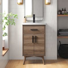 a bathroom vanity with a mirror above it and shelving on the wall next to it