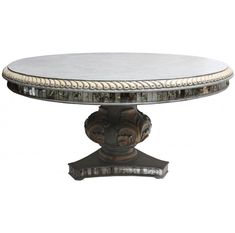 an ornately decorated table with white marble top and gold trim around the edges, on a metal base