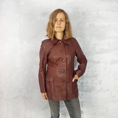 Vintage brown leather women's hip length jacket with lining. Features button fastening and two front pockets. Very stylish and elegant. Waist fitted genuine leather vintage outwear. Great quality clothing. ♥ Fabric: Genuine Leather ♥ Brand: Moda Polska ♥ Excellent vintage condition ♥ Size on the label missing ♥ We suggest size S, 10 (UK), 8 (US), 38 (EU),  but please check the measurement below Measured laid flat. Compare it to the measurements of the clothes you wear to make sure its the right fit. Armpit to armpit: 48 cm/ 19 inches Shoulder to shoulder: 41 cm / 16 inches Length: 71 cm / 28 inches Sleeve from armpit: 41 cm / 16 inches Sleeve from shoulder: 58 cm / 23 inches ♥ You will receive the exact item shown in the photos. There may be slight colour variation depending on your monito Retro Long Sleeve Leather Jacket For Work, Retro Winter Leather Jacket For Work, Retro Leather Jacket For Winter Workwear, Retro Single Breasted Leather Jacket With Long Sleeves, Retro Single-breasted Leather Jacket With Long Sleeves, Retro Leather Jacket With Pockets For Work, Retro Single Breasted Leather Jacket For Work, Retro Single Breasted Leather Jacket, Retro Leather Jacket With Snap Buttons For Winter