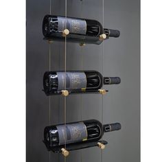 several bottles of wine are hanging from strings