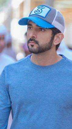 a man wearing a blue shirt and hat