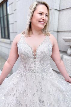 a woman in a wedding dress posing for the camera