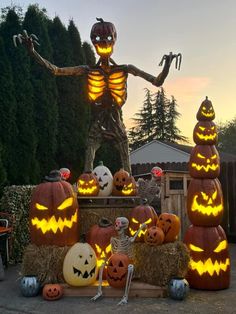 pumpkins and jack - o'- lanterns on display in front of a house