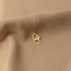 "Showing the bond and the love between you and your beloved one is easy with our diamond interlocking heart necklace. We know you have so much love to give. F E A T U R E S * Made to Order. * Gold KT: 14K * Choice of Gold Color: Yellow Gold, Rose Gold, White Gold * Gem Stone: Genuine Diamond * Diamond-Cut: Round * Diamond Carat: 0.01 ct * Pendant Height: 16 mm / 0.62 inch * Pendant Width: 10 mm / 0.39 inch * Diamond Color-Clarity: H Color, SI Clarity * Length: 14\", 16\", 18\", 20\", 22\" * Sett Intertwined Hearts, Real Gold Necklace, Double Heart Necklace, Heart Shaped Necklace, Heart Pendant Gold, Rose Gold White, Gold Diamond Necklace, Valentines Necklace, Handcrafted Necklace