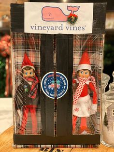 two christmas elves are in the packaging for wine