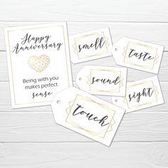 wedding anniversary gift tags with gold foil and black ink on white woodgrain background