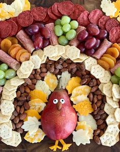 a turkey made out of crackers, grapes and nuts