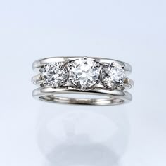 three stone diamond ring on white background