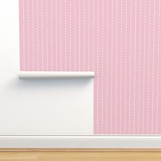 a pink wallpaper with white lines on it and a shelf in front of it