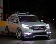 a silver car parked on the street at night