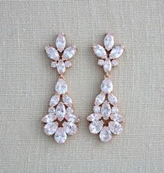 two pairs of earrings with crystal stones on the bottom and one pair in rose gold