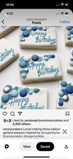 some cookies that are sitting on top of a white table with blue icing and the words happy birthday written on them