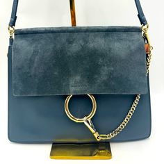 Authentic Chloe Faye Blue Leather And Suede Shoulder Bag Circa 2017-2018 Crafted From Supple Blue Calfskin Leather And Suede Foldover Flap Gold-Tone Hardware Snap Closure Under Flap With Ring And Chain Design Accordion Style Interior With Three Compartments Lined In Beige Suede One Interior Zip Pocket Removable Strap To Use Handbag As A Clutch Size 12.6”W X 10.9”H X 2”D (Laying Flat) Strap Drop: 12” Condition This Faye Shoulder Bag By Chloe Is In Very Good Condition With Minor Signs Of Wear Incl Chloe Faye, Chain Design, Chloe Bag, Blue Leather, Suede Leather, Snap Closure, Calf Skin, Chloe, Zip Pockets