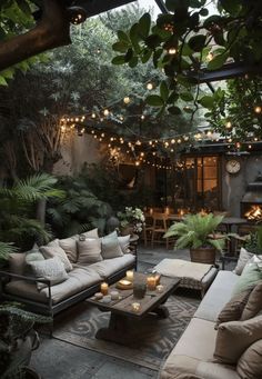 an outdoor living area with couches, tables and lights