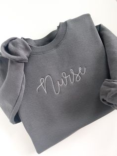 Custom Nurse Sweatshirt! New Grad Nurse Gift or Perfect for any occasion or as a gift to say thank you to your favorite medical professional!  Super Soft and Comfy!  Gildan 50/50 Unisex Crewneck in Charcoal with light grey thread. Color may slightly vary depending on what kind of device you are viewing on. Please allow 3-5 business days for processing as these are made to order. I ship through the USPS. Care: For best results, Turn Inside Out! Wash on gentle cycle. Air Dry. Iron as needed.  No returns due to health and safety reasons.  Unisex Sizing. Please refer to Size Chart to ensure a perfect fit. Embroidered Relax Fit Sweatshirt For Gift, Embroidered Relaxed Fit Sweatshirt For Gift, Embroidered Relaxed Fit Sweatshirt As Gift, Embroidered Logo Sweatshirt As A Gift, Long Sleeve Sweatshirt With Embroidered Logo Gift, Embroidered Logo Long Sleeve Sweatshirt, Crew Cotton Top With Machine Embroidery, Cotton Crew Top With Machine Embroidery, Cotton Crew Neck Top With Machine Embroidery