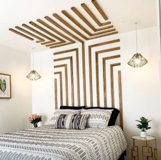 a bedroom with white walls and wood slats on the headboard