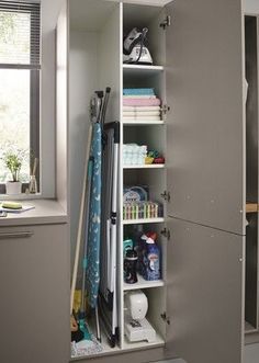 an organized closet in the corner of a room