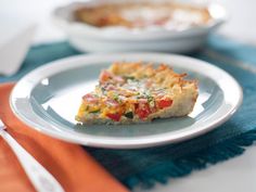 a piece of quiche sitting on top of a white plate