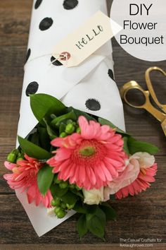 a bouquet of flowers sitting on top of a table next to a pair of scissors