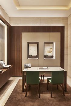 a dining room table with two green chairs