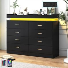 there is a black dresser with yellow drawers