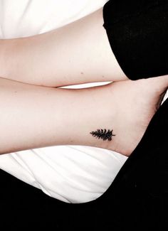 two women's legs with small trees on them