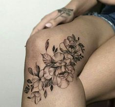 a woman's thigh with flowers on it